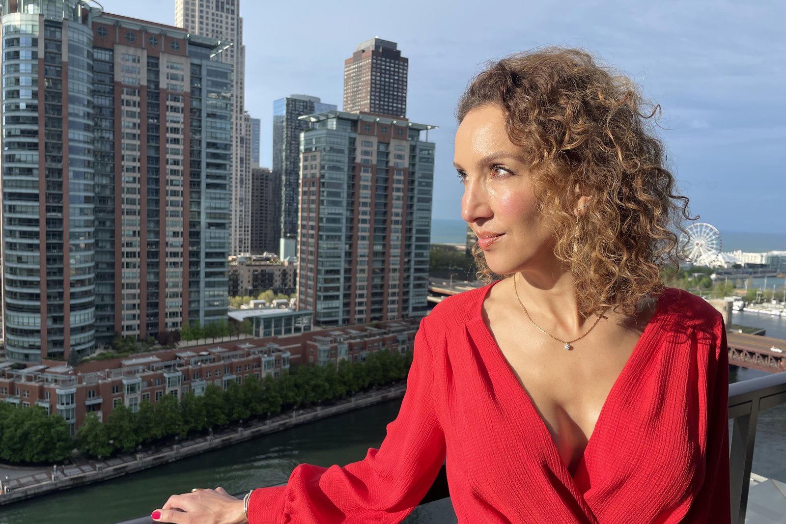 Woman in a red dress overlooking Chicago.